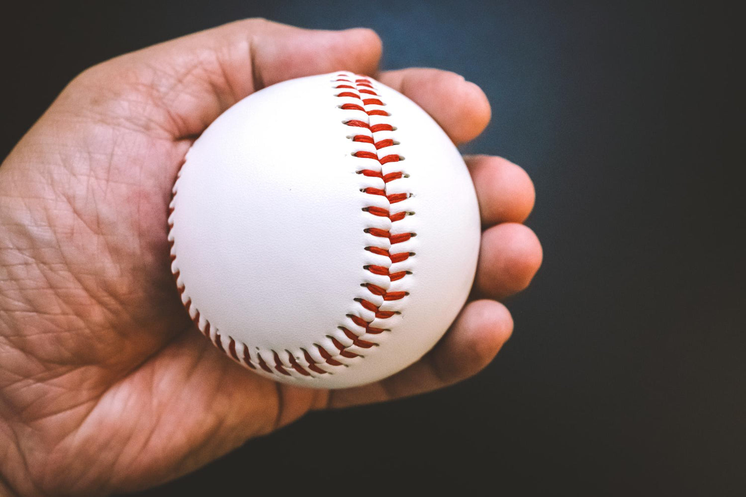 hand holding a baseball