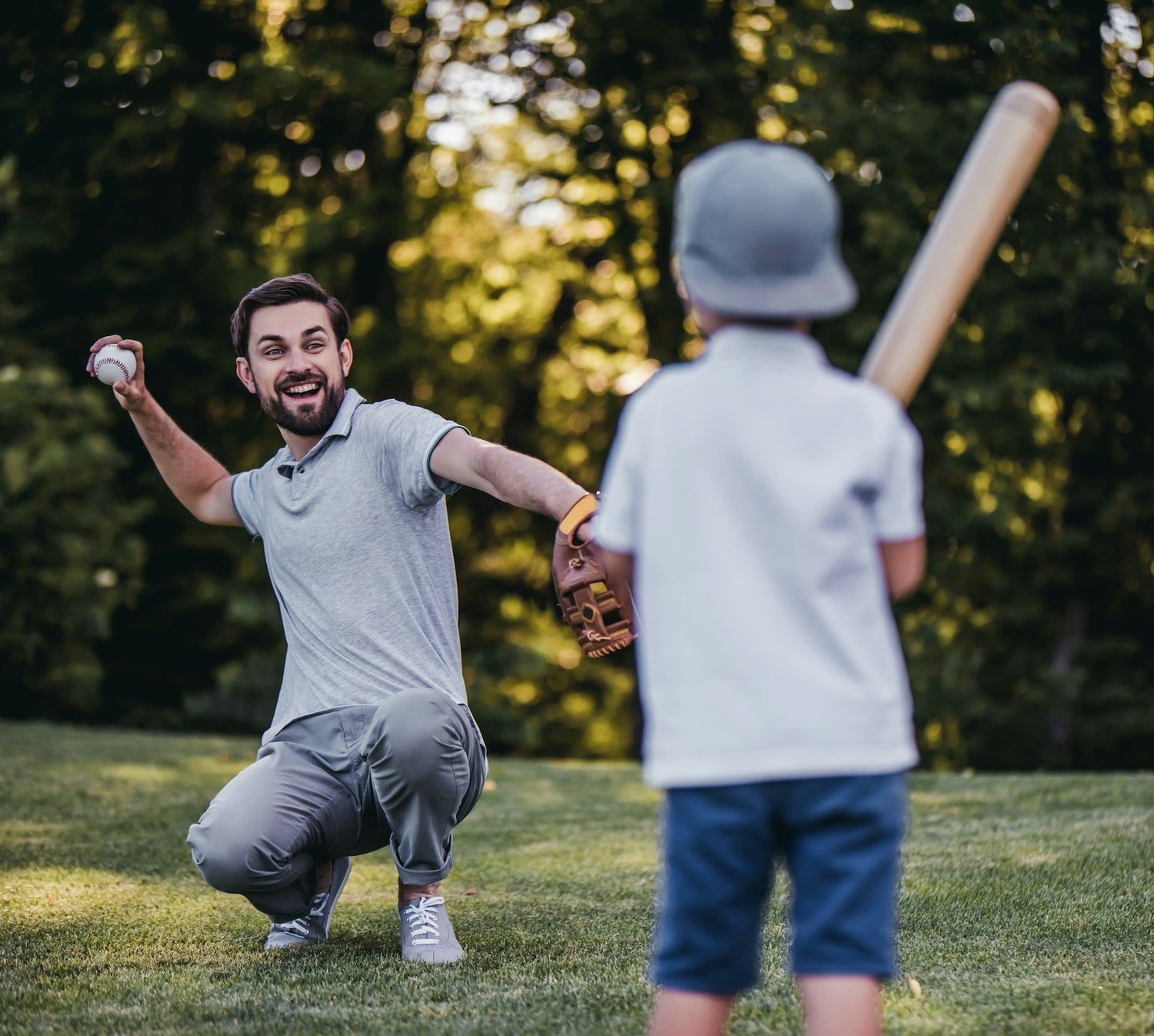kid playing baseball with his dad